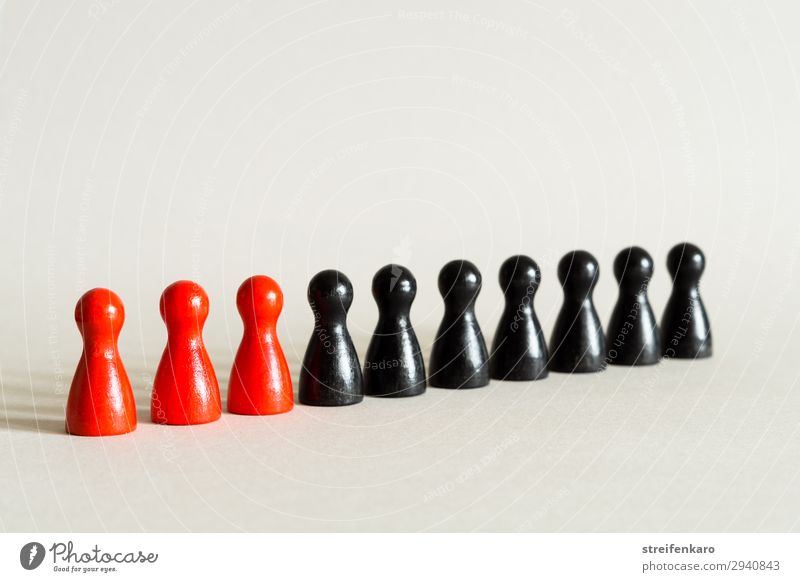 Three red game pieces stand in a row with seven black game pieces Group Toys Wood Stand Esthetic Simple Red Black Force Conscientiously Truth Authentic