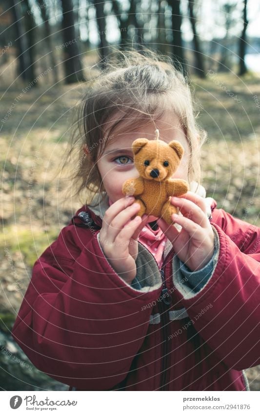 Little girl playing with her little teddy bear toy in a park Lifestyle Joy Beautiful Playing Summer Child Woman Adults Infancy Park Playground Jacket Toys