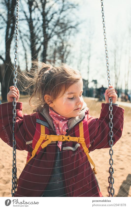 Little cute girl swinging in a park on sunny spring day Lifestyle Joy Beautiful Playing Summer Child Woman Adults Infancy Park Playground Jacket To enjoy