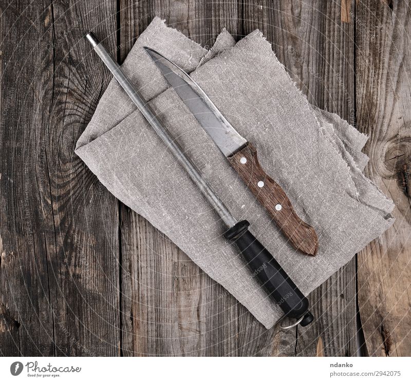 knife with sharpening on the wooden table Knives Table Kitchen Work and employment Tool Wood Metal Steel Rust Old Dirty Retro Brown background Blank board