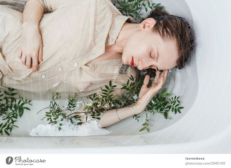 Woman Lying In Bathtub Filled With Charcoal Water A Royalty Free Stock Photo From Photocase