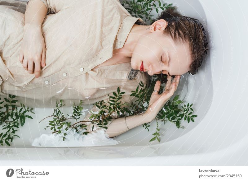 Female lying in bathtub with pistachio branches Attractive Swimming & Bathing Bathroom Bathtub Beautiful Branch Personal hygiene Caucasian eyes closed Woman