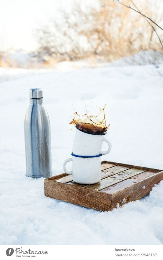 Two enamels mugs with splashing coffee outdoors Vacation & Travel Cup Mug Enamel Splash Autumn Exterior shot Tray Box Hiking Picnic Metal Bottle thermos Brown