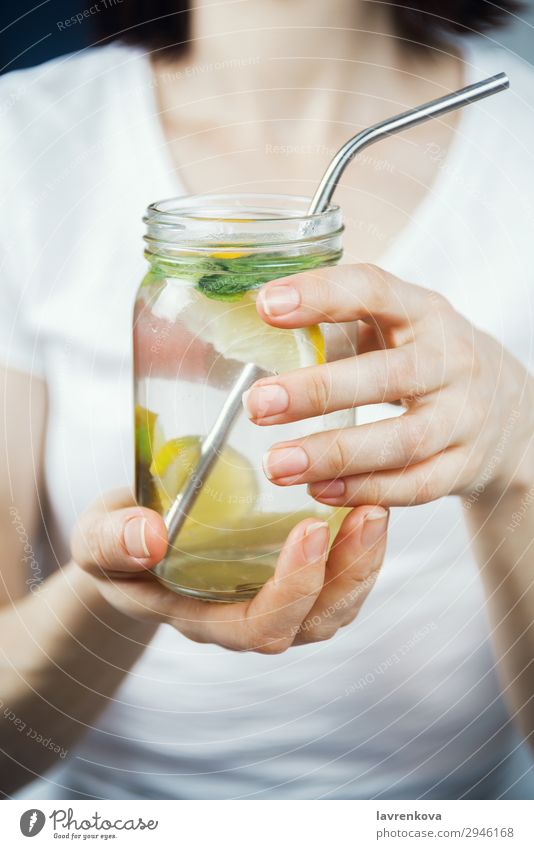 woman holding mason jar with sassy lemon and mint water Straw Metal Lemon Citrus fruits focus Selective Breakfast Beverage Drinking Mint Lime Water