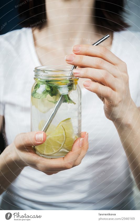woman holding mason jar with sassy lemon and mint water Straw Metal Lemon Citrus fruits focus Selective Breakfast Beverage Drinking Mint Lime Water Hand Green