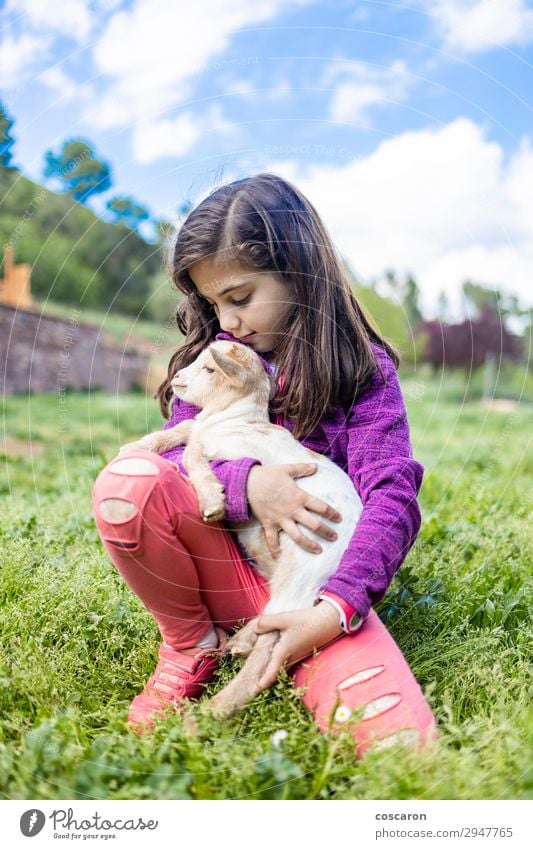 Little girl hugging a goat on a field Lifestyle Happy Beautiful Leisure and hobbies Playing Vacation & Travel Tourism Summer Garden Child Human being Feminine