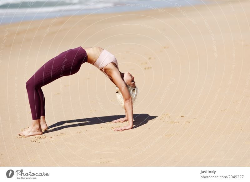 Woman practicing yoga on the beach, Woman practicing yoga o…