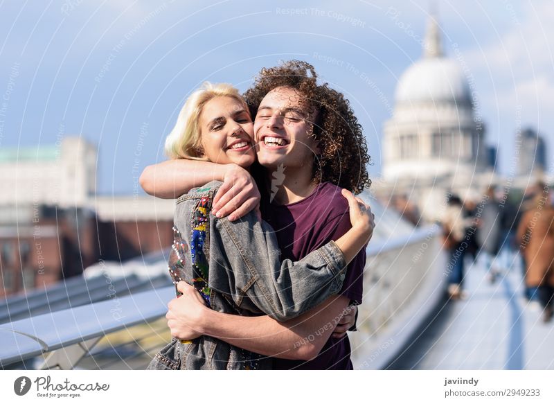 Happy couple hugging by Millennium bridge, River Thames, London. Joy Human being Masculine Feminine Young woman Youth (Young adults) Young man Woman Adults Man