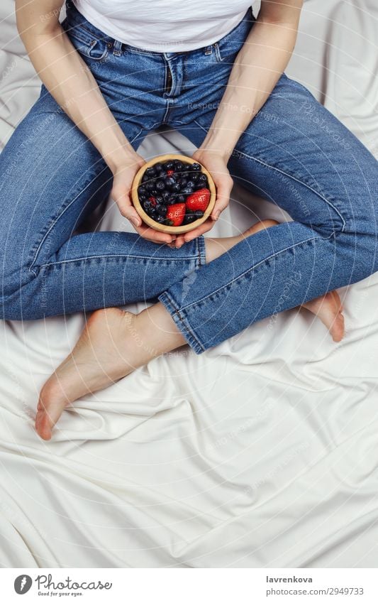 woman holding wooden bowl with organic berries Above Bed Bedclothes Bedroom Blueberry Bowl Denim Diet Faceless Woman Fresh Young woman Hand Healthy