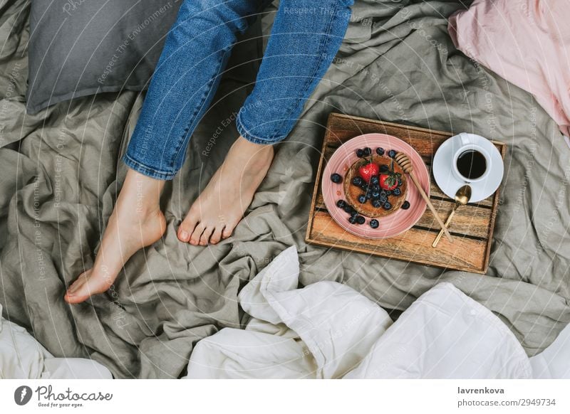 woman sitting on a bed with healthy breakfast Above Bed Bedclothes Bedroom Blueberry Bowl Denim Diet Faceless Woman Fresh Young woman Hand Healthy