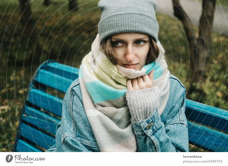 young adult woman sitting on a bench wrapped in scarf Adults Loneliness Attractive Autumn Beautiful Bench Caucasian Cold Denim Woman Forest Young woman Hair