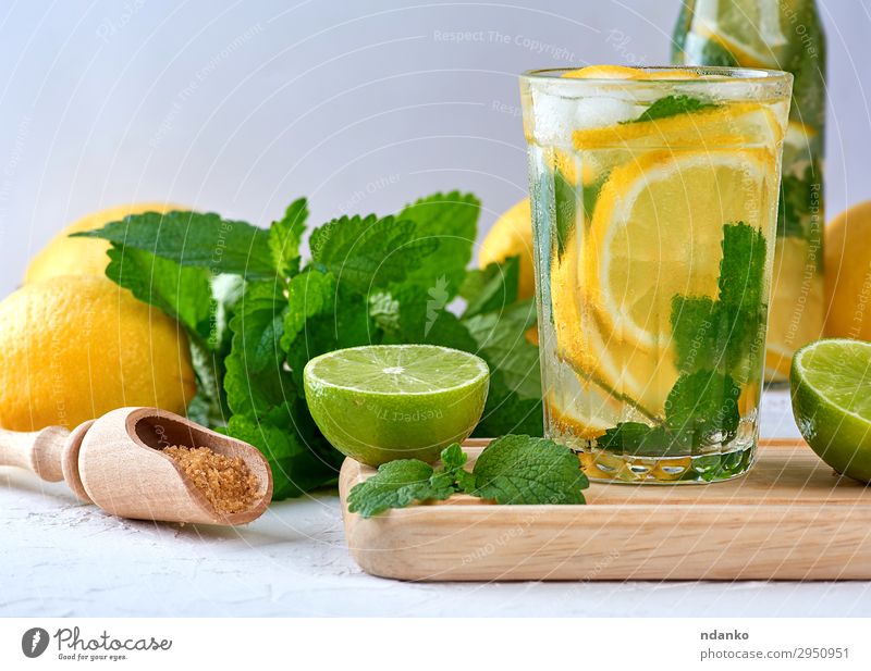 summer refreshing drink lemonade with lemons Fruit Herbs and spices Vegetarian diet Beverage Cold drink Lemonade Juice Alcoholic drinks Glass Spoon Summer Table