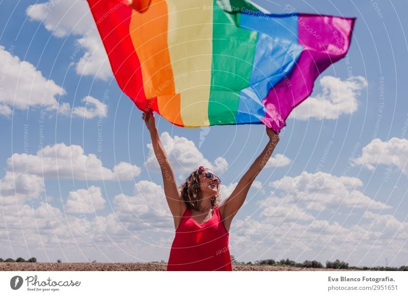 Woman holding the Gay Rainbow Flag over blue sky Lifestyle Joy Happy Leisure and hobbies Freedom Summer Sun Wedding Human being Feminine Homosexual Young woman