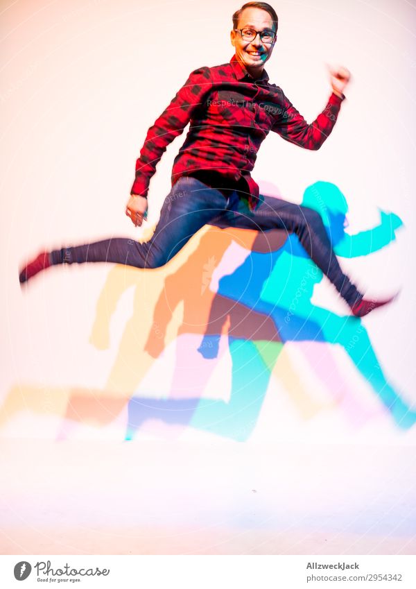 young man jumps into the air with three-coloured shadow 1 Person Young man Man Masculine Jump Unicoloured Feasts & Celebrations Rocking out Wild Exuberance Romp
