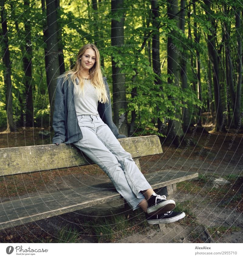 Young woman sitting on a bench in a forest Joy pretty Wellness Life Youth (Young adults) 18 - 30 years Adults Nature Landscape Beautiful weather Forest Jeans