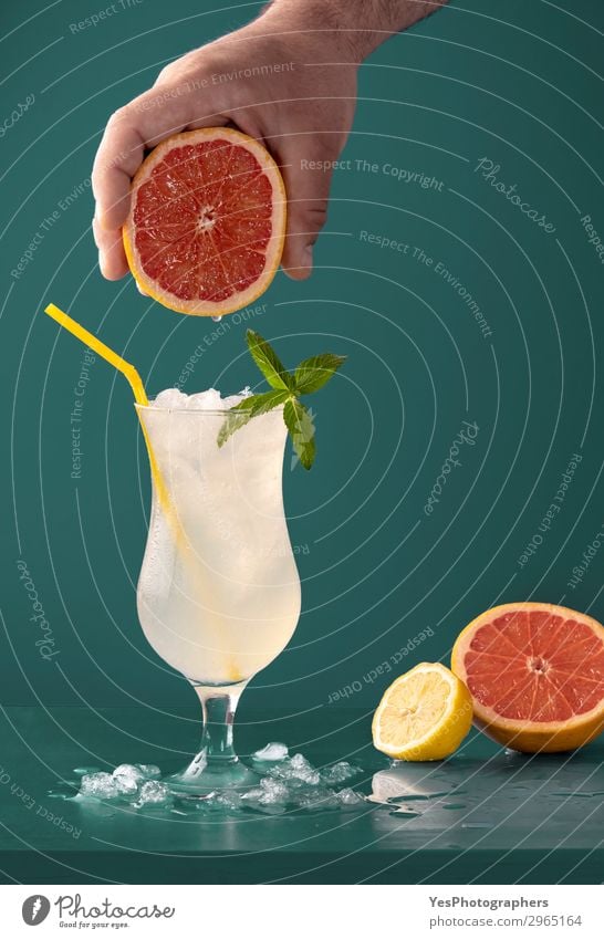 Lemonade cold drink with grapefruit aroma Fruit Diet Beverage Cold drink Juice Summer Fresh Juicy Yellow Green Aromatic Blue background citrus Cocktail