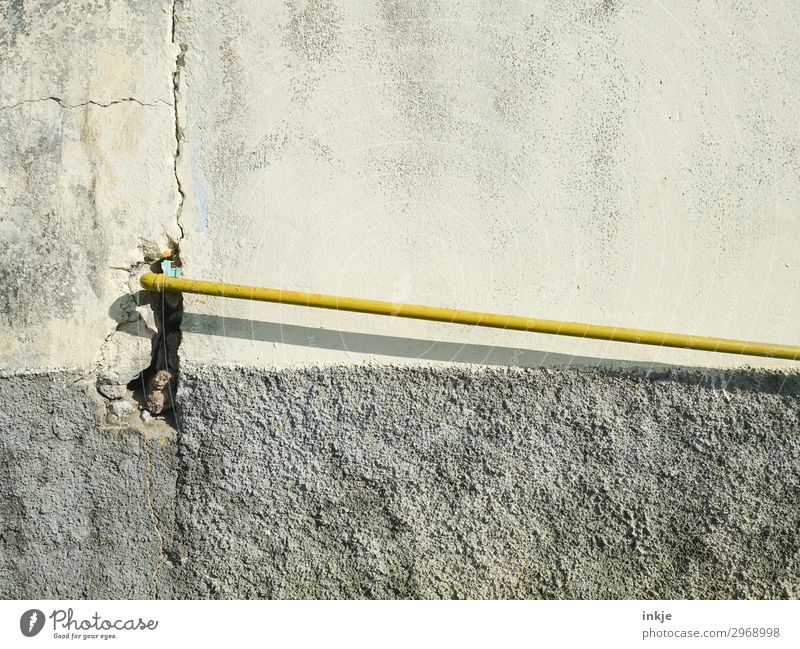 aquatic Cable Technology Deserted Wall (barrier) Wall (building) Facade Pipe Water pipe Conduit Thin Long Yellow Gray Colour photo Exterior shot Close-up Detail