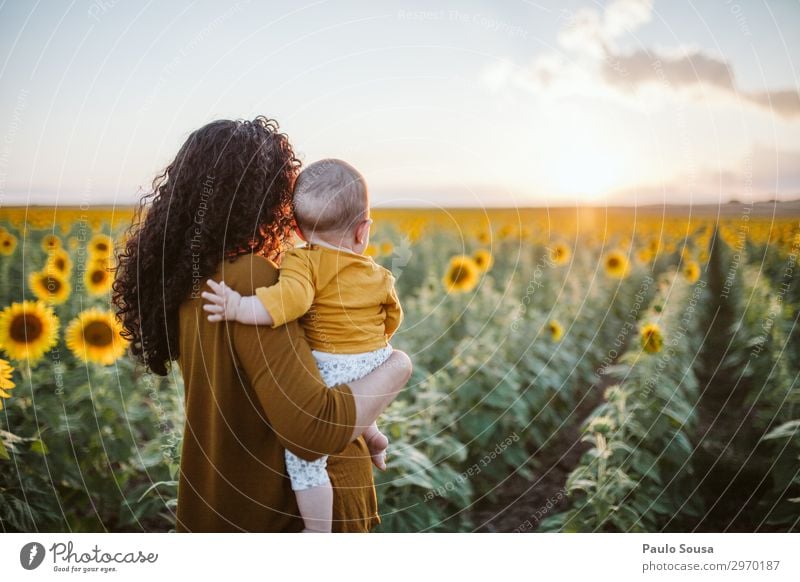 Mother and Daughter in sunflower field Lifestyle Human being Feminine Child Baby Toddler Girl Adults 3 0 - 12 months 18 - 30 years Youth (Young adults)