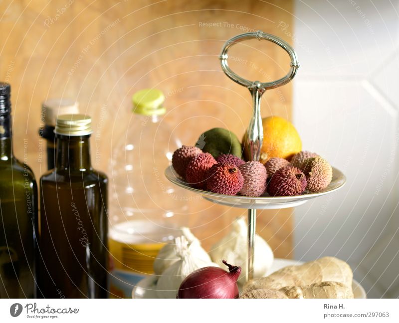 KitchenStill with Lychees Food Fruit Nutrition Olive oil Crockery Authentic Fresh Bright Delicious onions Lemon Ginger Garlic Bottle Wooden board Tile