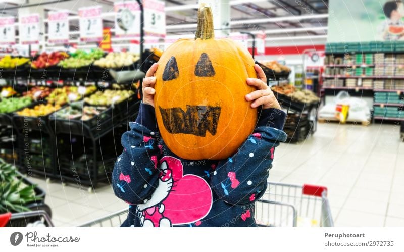 Little girl holding a pumpkin in her hands, on Halloween. Vegetable Joy Happy Decoration Feasts & Celebrations Hallowe'en Child Human being Woman Adults Infancy