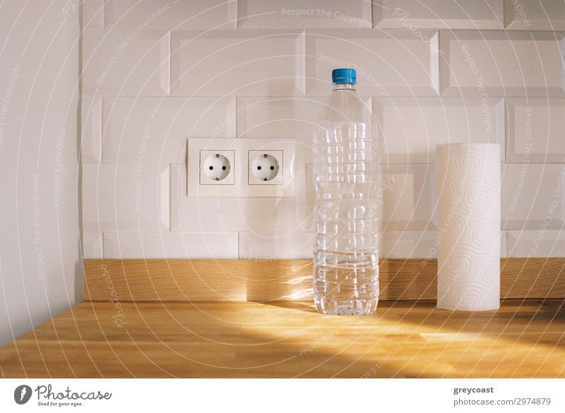A minimalistic kitchen still-life with a paper towel, a plastic bottle and an electric outlet Living or residing Flat (apartment) Kitchen Packaging Package