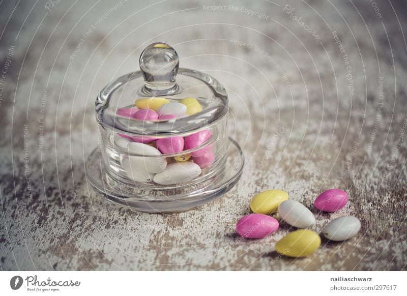 sweet sin Food Dessert Candy Chocolate Nut sugared almond Bowl Glass To enjoy Delicious Natural Positive Round Beautiful Sweet Multicoloured Yellow Gray Pink