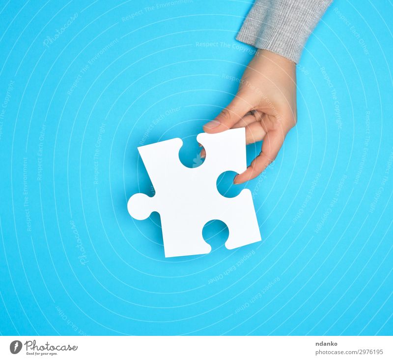 female hand holding white empty paper puzzle Playing Work and employment Business Hand Blue White Colour Idea Creativity Crisis Teamwork people
