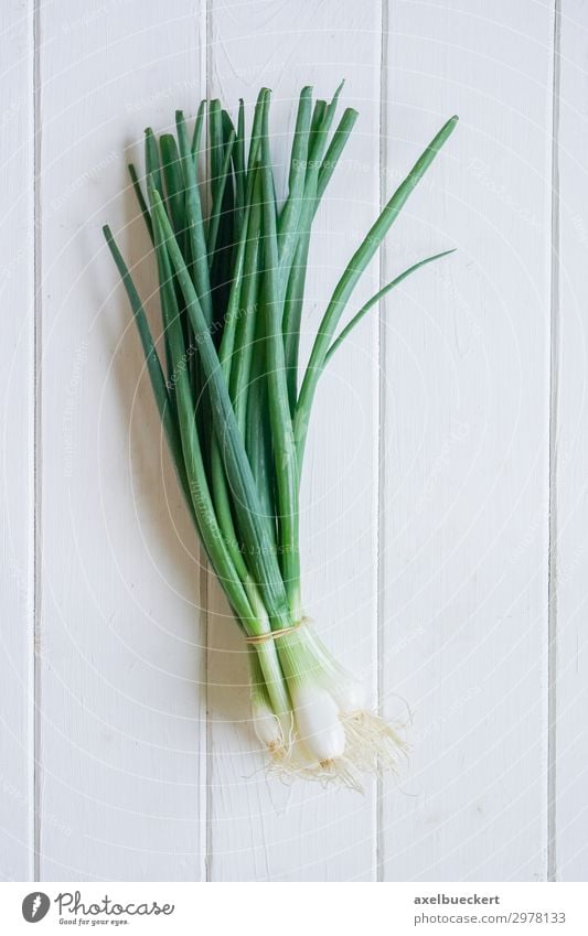 bunch spring onions Food Vegetable Nutrition Vegetarian diet Healthy Eating Fresh Cooking Kitchen Table Wooden table Wooden board Leek vegetable Early onion