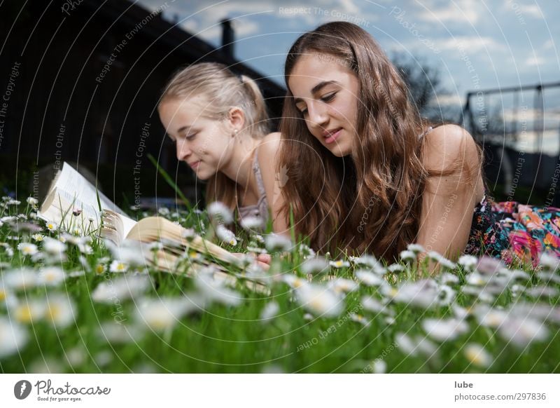 Reading in the green grass Contentment Education Study Human being Feminine Girl Brothers and sisters Youth (Young adults) 2 13 - 18 years Child Book Grass