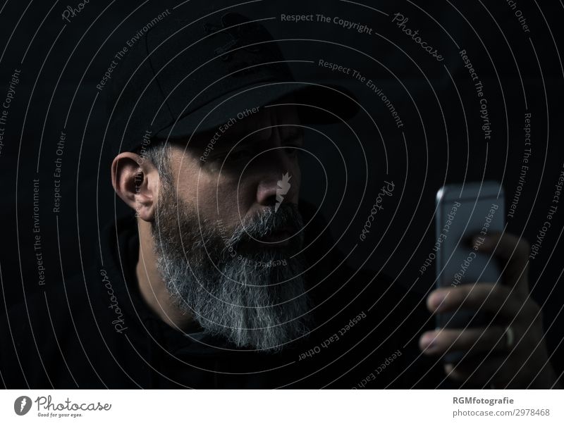 bearded man looking at a mobile device Human being Masculine Man Adults Male senior Head Facial hair 1 30 - 45 years Subculture Internet Email Instant messaging