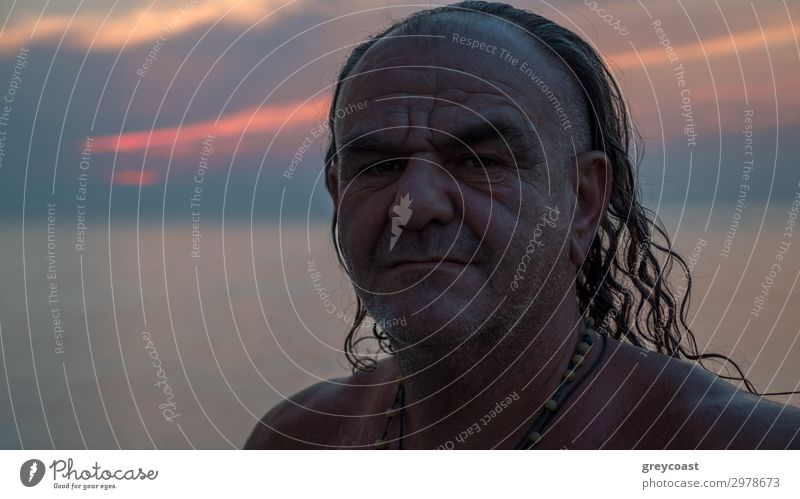 A portrait of a middle-aged man with long hair and a couple of necklaces on his naked chest Lifestyle Summer vacation Masculine Man Adults Male senior