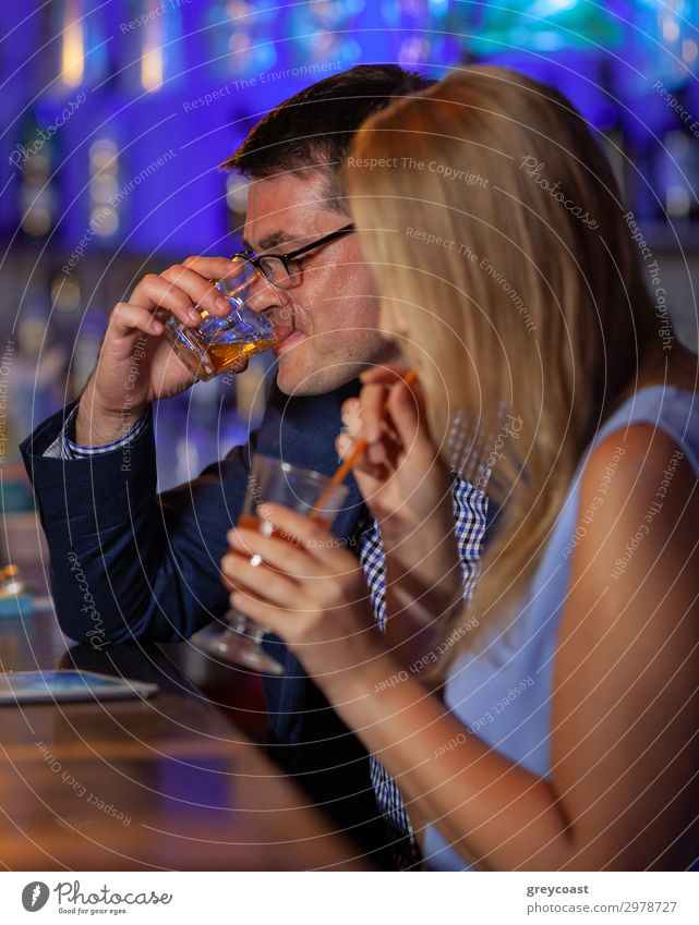 Young man and woman relaxing in the bar and having drinks. Nightlife and hanging out Beverage Alcoholic drinks Relaxation Night life Restaurant Club Disco