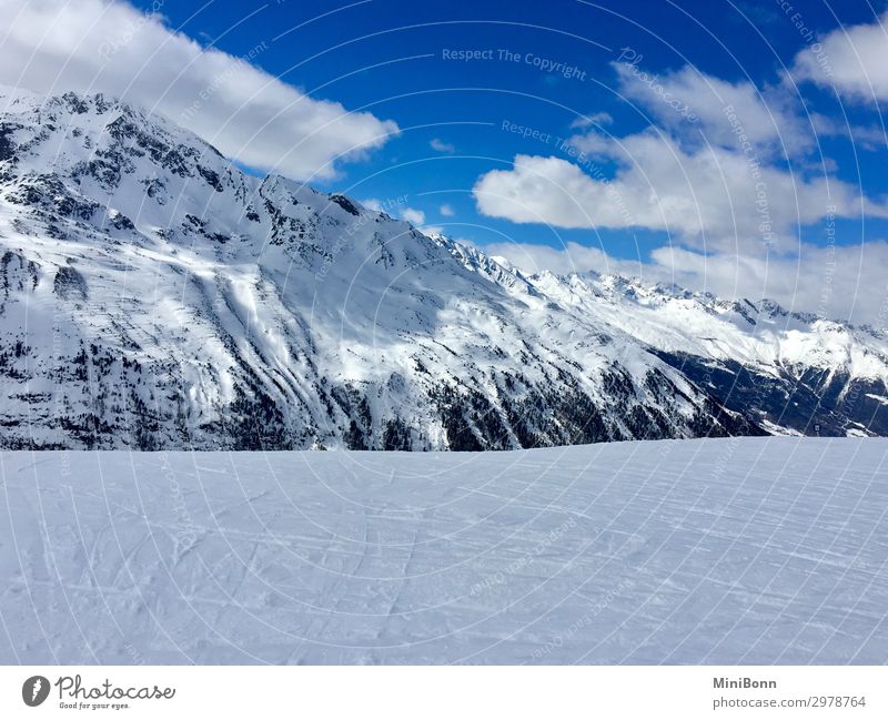 Snow-covered mountains Calm Winter Winter vacation Mountain Winter sports Skiing Snowboard Nature Sky Clouds Alps Peak Snowcapped peak Austria Relaxation Cold