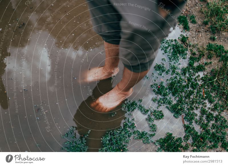 feet of a man standing inside a big puddle after a heavy rain Lifestyle Vacation & Travel Tourism Summer Summer vacation Human being Masculine Legs Feet 1