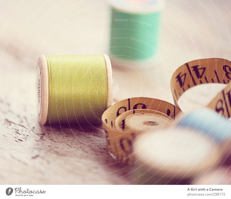 old thread Sewing thread Tape measure Yellow Green Old Old fashioned accessories Craft (trade) Tailoring Rolled Subdued colour Deserted Shallow depth of field