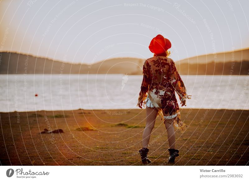 a young woman with red hat in a romantic sunset in a lake Lifestyle Elegant Design Exotic Joy Human being Feminine Young woman Youth (Young adults) Woman Adults