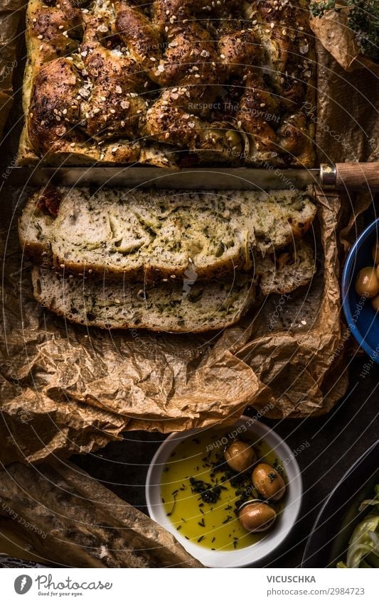 Close up of fresh baked homemade focaccia bread  with olives oil, top view. Traditional italian bread. Authentic Italian cuisine concept. Dark. Rustic style
