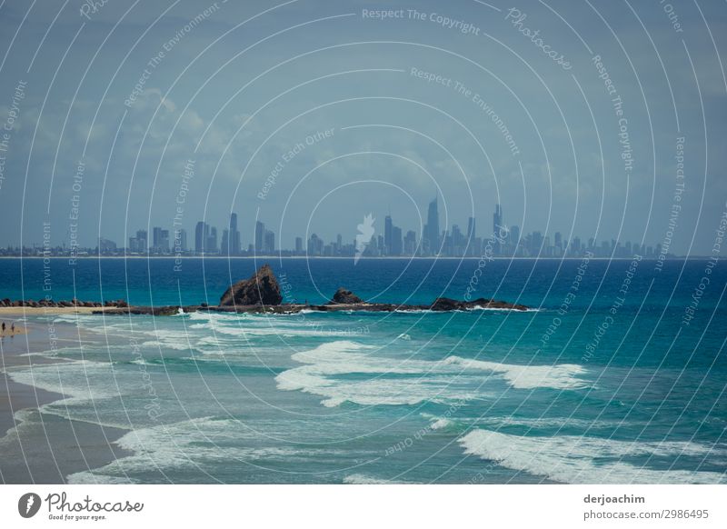 Isolation / rocks in the water and in the background the city with the contours of the high-rise buildings of Surfers Paradise Joy Harmonious Well-being Trip