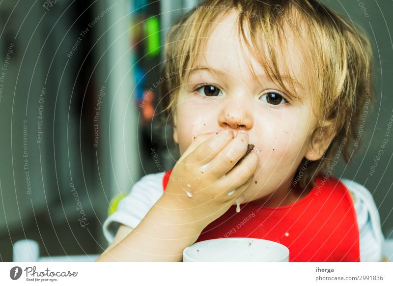 portrait adorable child eating chocolate sponge cake Chocolate Eating Milk Child Baby Boy (child) Infancy Face Hand 1 Human being 1 - 3 years Toddler Smiling