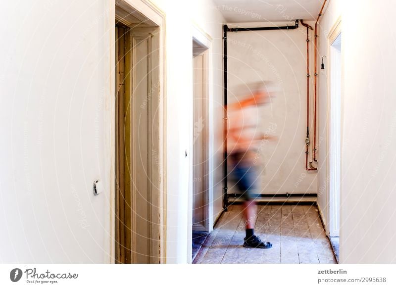 Man from left to right Old building Wooden board Hallway Wooden floor Floor covering Wall (barrier) Human being Room Interior design Copy Space Blur