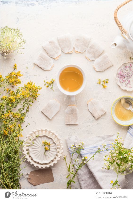 Cup of herbal tea with frame of tea bags Food Herbs and spices Organic produce Beverage Hot drink Tea Crockery Style Healthy Healthy Eating Plant Yellow White