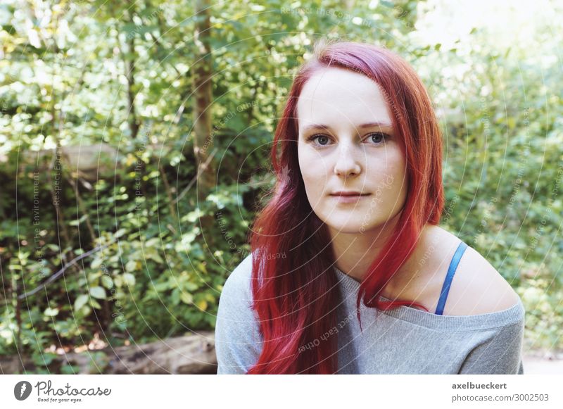 Young redhead woman covered by a book - a Royalty Free Stock Photo from  Photocase