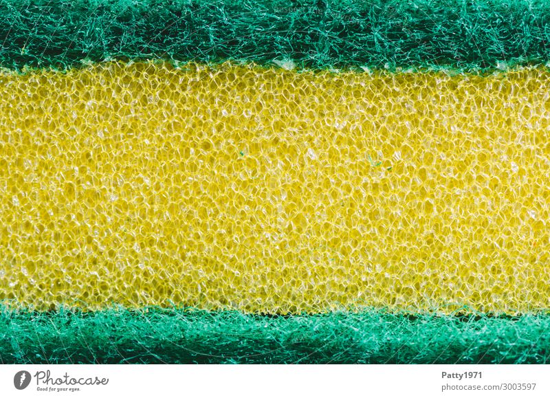 Stack kitchen sponges on yellow table background. Cleaning sponge