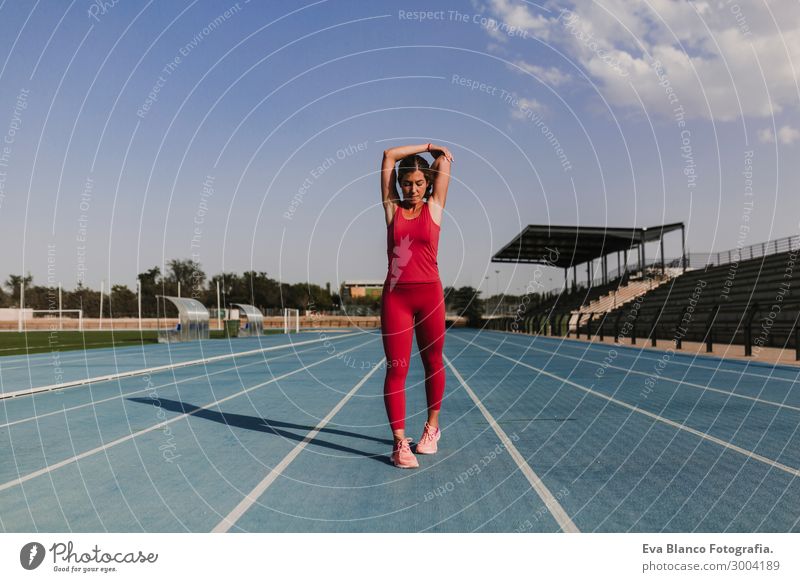 fitness woman runner stretching arms on stadium. Healthy life Lifestyle Beautiful Relaxation Leisure and hobbies Sports Fitness Sports Training Track and Field