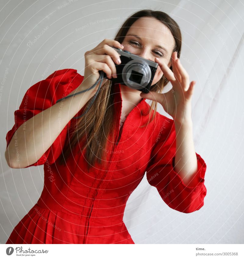 Woman in red dress with camera Curtain Camera Feminine Adults 1 Human being Dress Cloth Brunette Long-haired Observe To hold on Laughter Looking Happiness