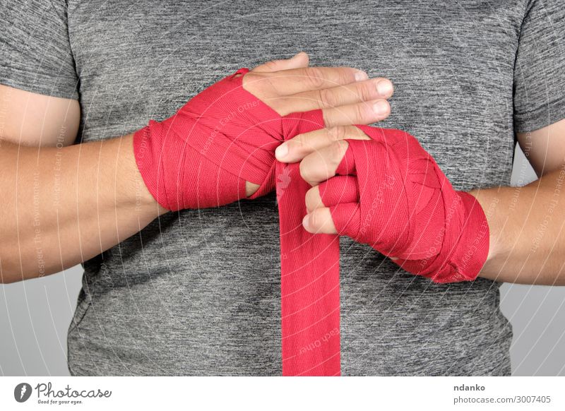 sportsman’s hands wrapped in a red elastic sports bandage Lifestyle Body Athletic Fitness Sports Human being Masculine Man Adults Hand Movement Stand Aggression