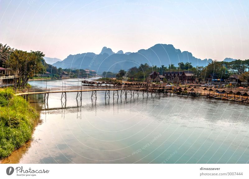 Vang Vieng with the river, Laos Vacation & Travel Tourism Summer Mountain Environment Nature Landscape Sky Clouds Lake River Village Town Skyline Bridge
