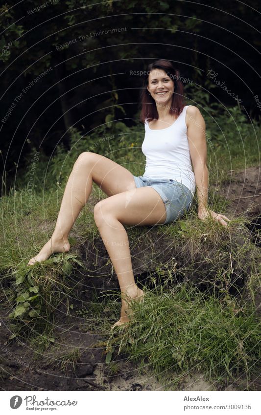 Portrait of a tall young woman on a fragile lake shore in front of a forest Lifestyle Joy luck already Relaxation Young woman Youth (Young adults) Legs