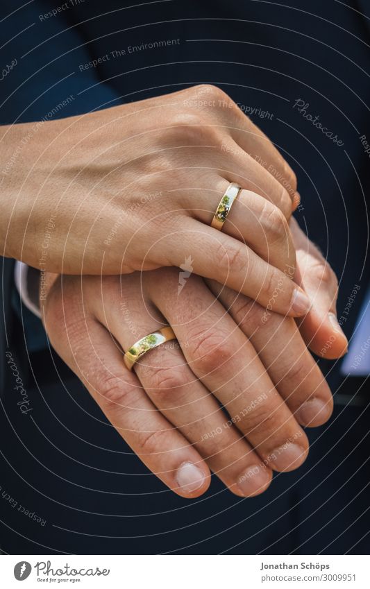 Man And Woman's Hand With Pair Of Golden Engagement Rings Stock Photo -  Alamy