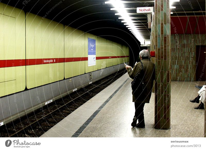 emergency stop Underground Man Newspaper Green Munich Human being